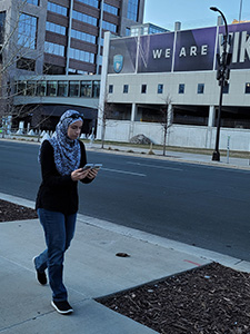Eman Ramadan conducting a walking loop test comparing 4G and 5G performance near US Bank Stadium in Minneapolis, Minnesota